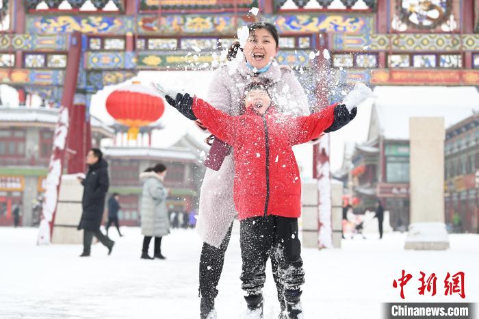 2月13日，家長與小朋友在呼和浩特市大召廣場享雪趣?！⑽娜A 攝