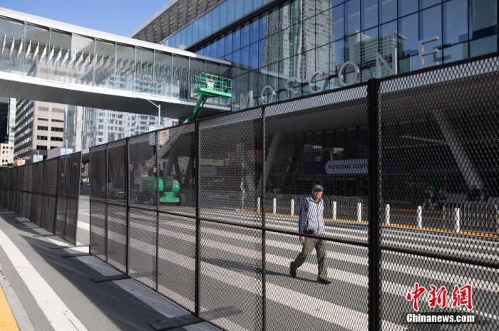 當?shù)貢r間11月10日，一名行人從美國舊金山莫斯康中心周圍的金屬圍欄旁經(jīng)過。隨著亞太經(jīng)合組織(APEC)第三十次領(lǐng)導人非正式會議臨近，作為會議場地的莫斯康中心附近出現(xiàn)金屬圍欄，執(zhí)勤警察也大幅增加。<a target='_blank' href='/'><p  align=