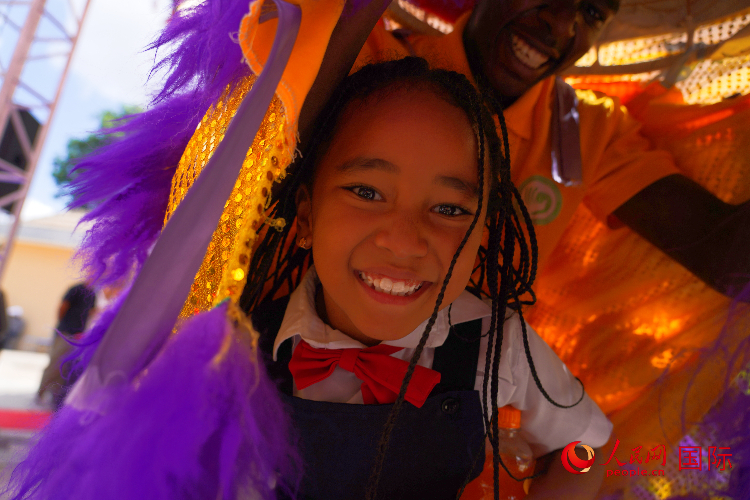 一名小朋友在與舞獅表演者互動(dòng)。人民網(wǎng)記者 黃煒鑫攝