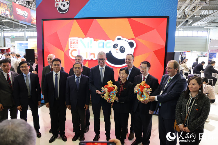 參加中國館開幕式的嘉賓們在“你好 中國” 展臺前合影留念。