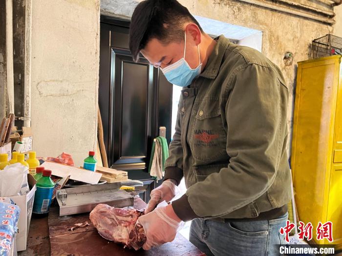 圖為雪豹“奶爸”史壽軍正在準(zhǔn)備投喂雪豹的食材?！●R銘言 攝