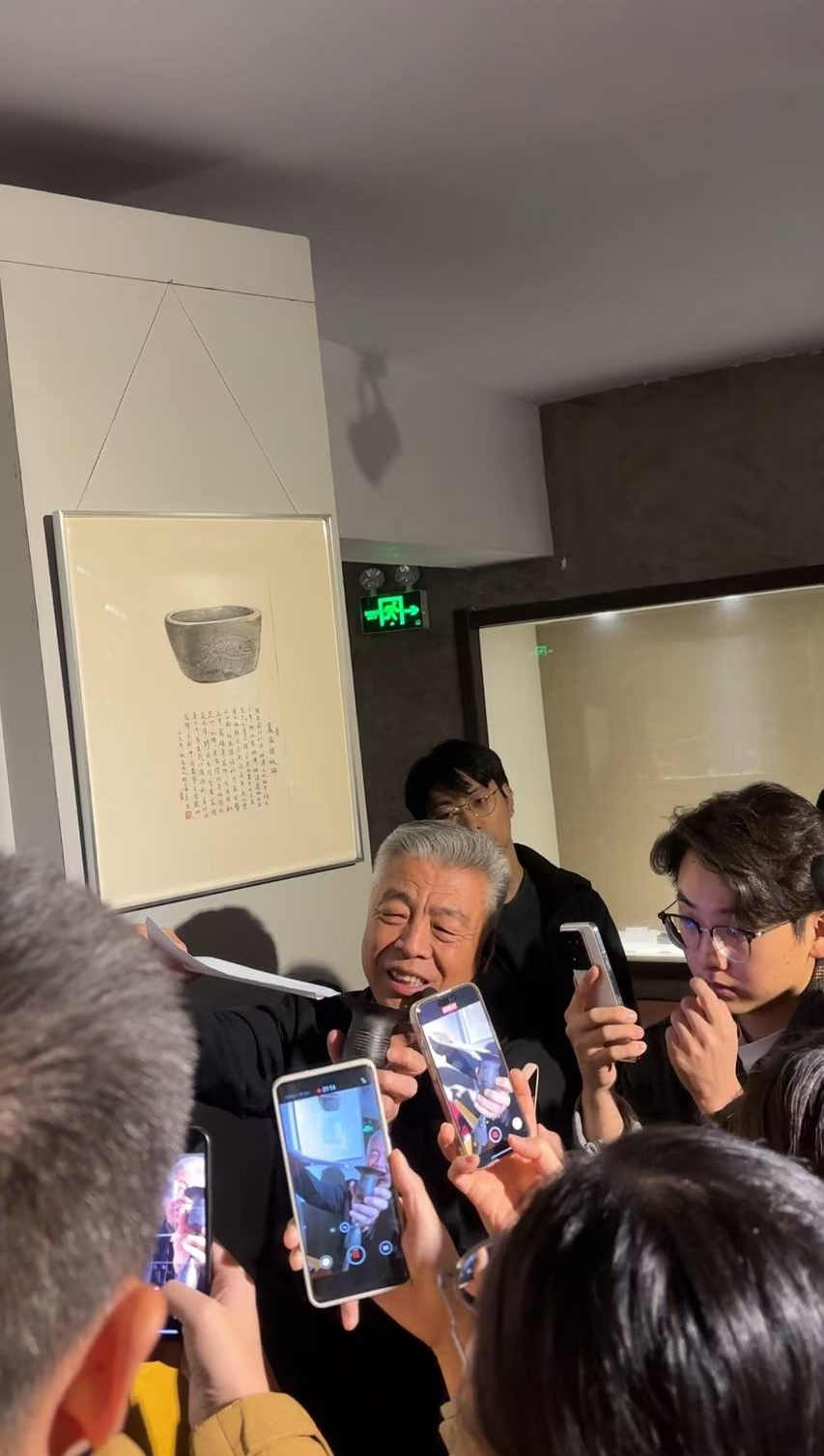 黑陶邢文化博物館館長邢葆東展示兩張相疊的A4紙，向記者解釋此為杯口的厚度。