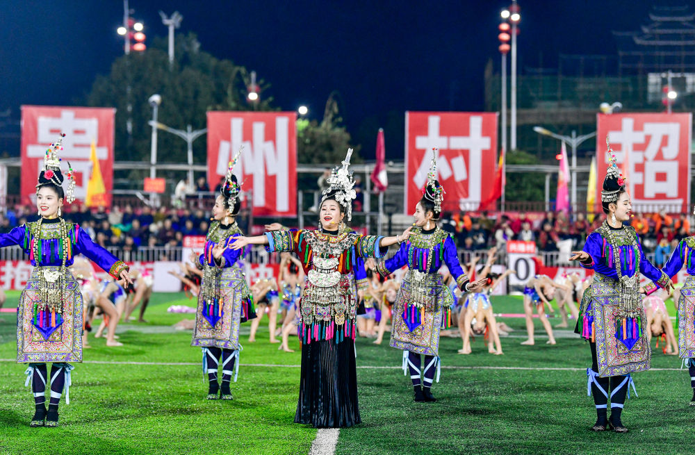 2025年3月14日，2025年貴州“村超”40強(qiáng)交叉賽在榕江“村超”足球場(chǎng)舉行，演員在比賽間隙表演侗族大歌，民族文化伴隨著體育賽事成功“出圈”。圖片來源：新華社