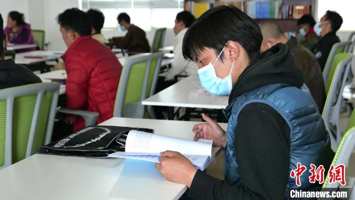 圖為正在閱讀“杰松達(dá)孜”藏歷法教材的學(xué)員?！≈x牧 攝