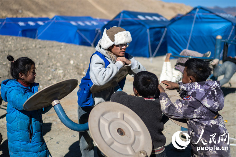 西藏星光社會(huì)工作服務(wù)中心社工久米旦增通過(guò)聊天談心，對(duì)孩子們進(jìn)行災(zāi)后心理疏導(dǎo)。人民網(wǎng)記者 翁奇羽攝